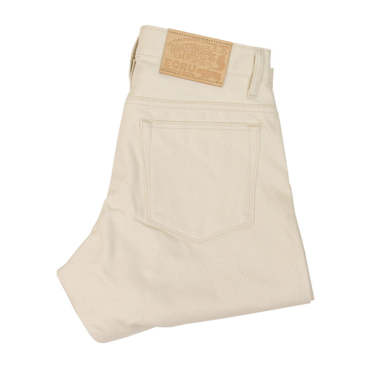 Folded Pair of X105 12 Oz Ecru Natural Selvedge Jeans showing back pocket and leather