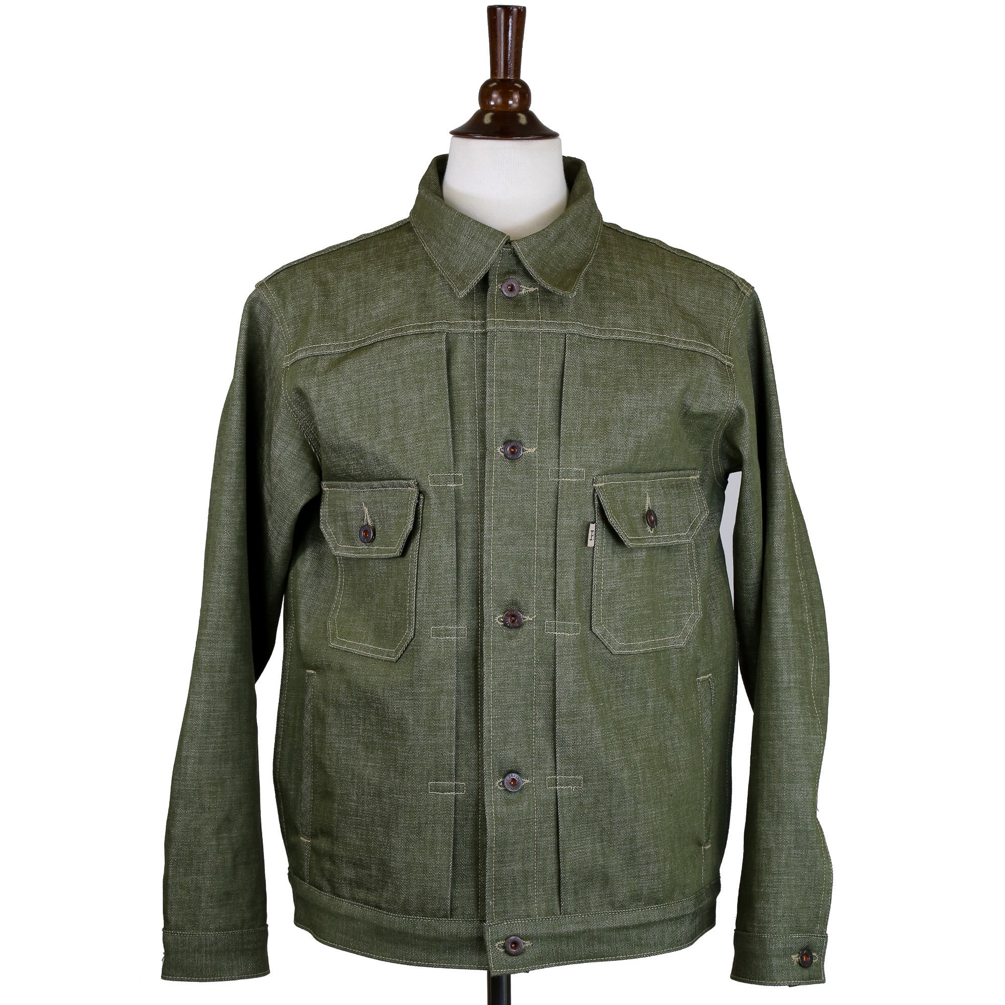 A Type 2 X079 13.5 Ounce Pistachio Green, medium-weight red line selvedge denim jacket with hand welted pockets and a vintage washer burr riveting detail