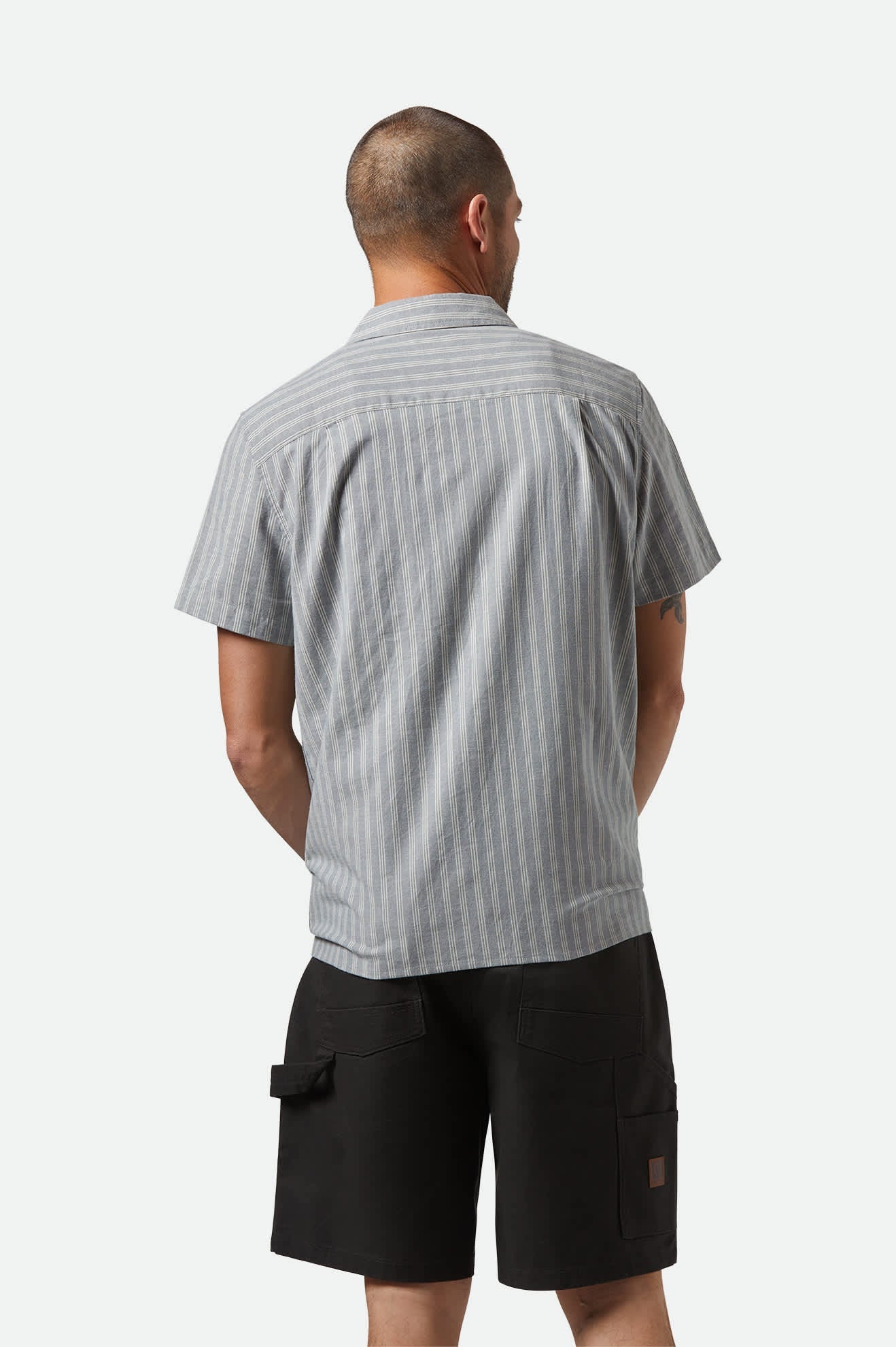 Model Photo of Back of Brixton Men's Cru Oxford Strip Short Sleeve Shirt - Basalt Blue/Whitecap Stripe 