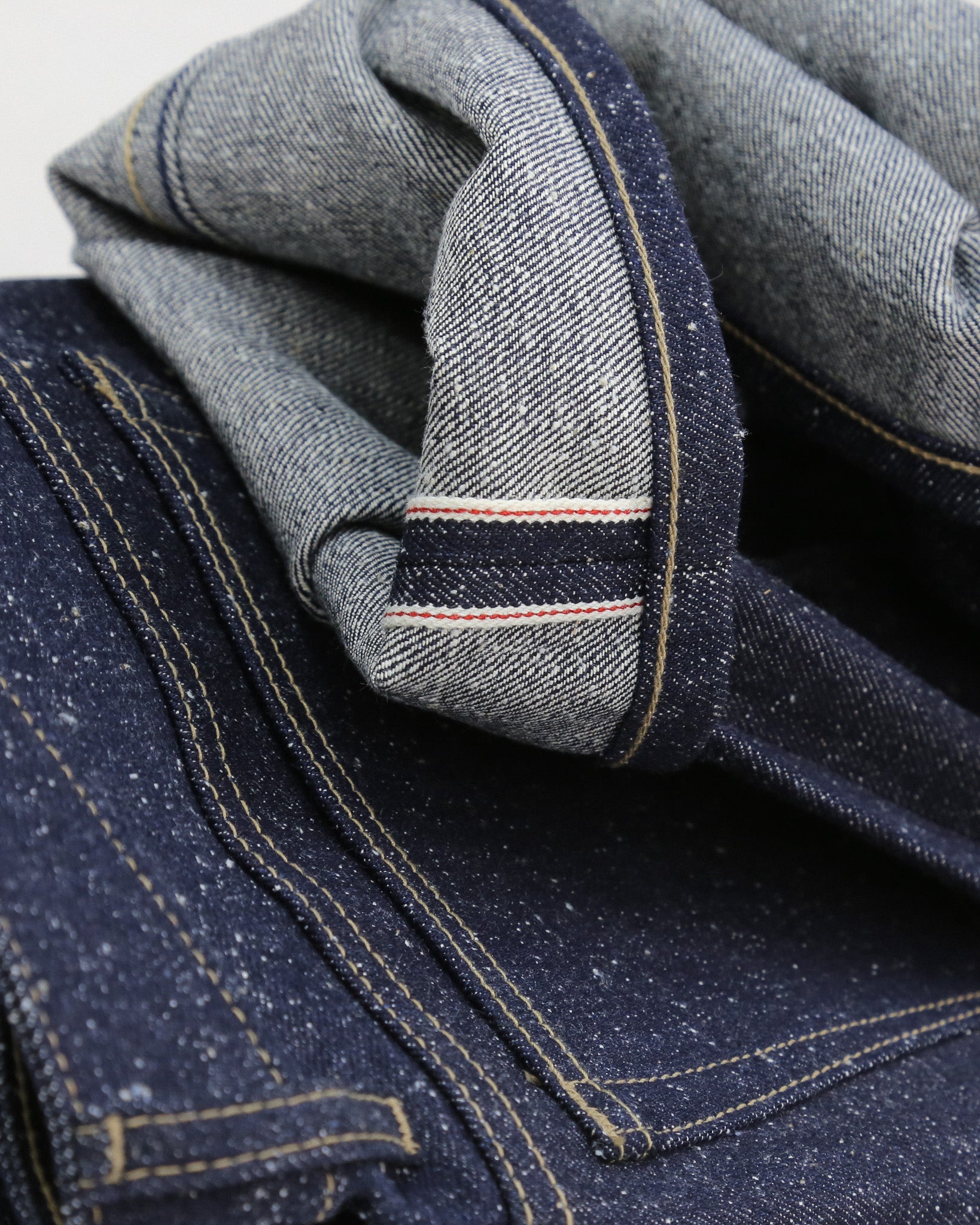 Close-up of cuff of X125 Super Nep denim fabric with a focus on stitching and texture.