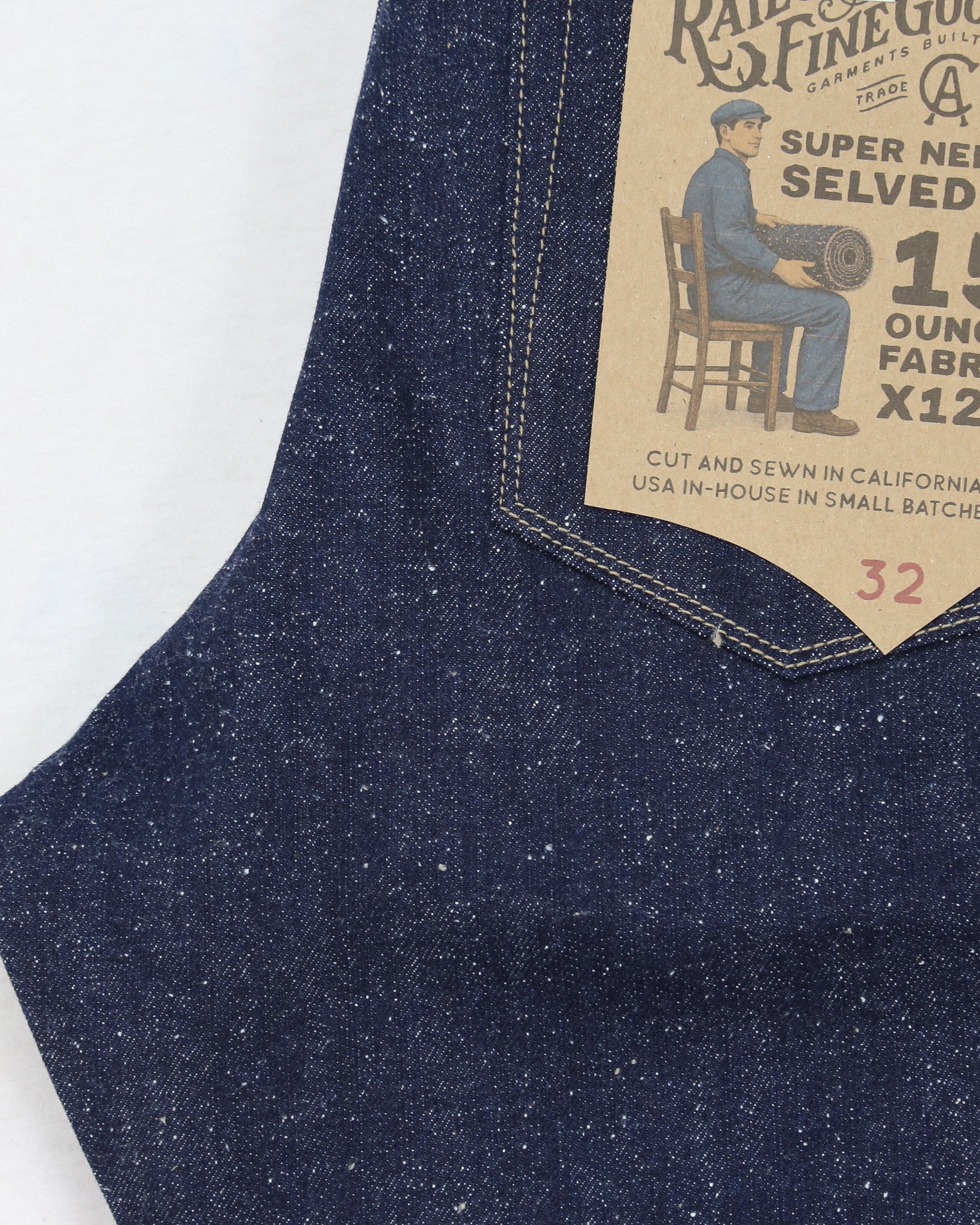 Close-up of X125 denim fabric with a brand label on a white background